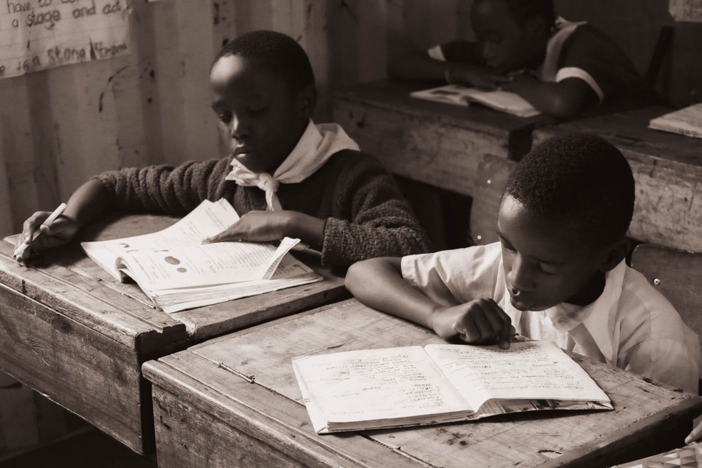 A child reading at a school desk.