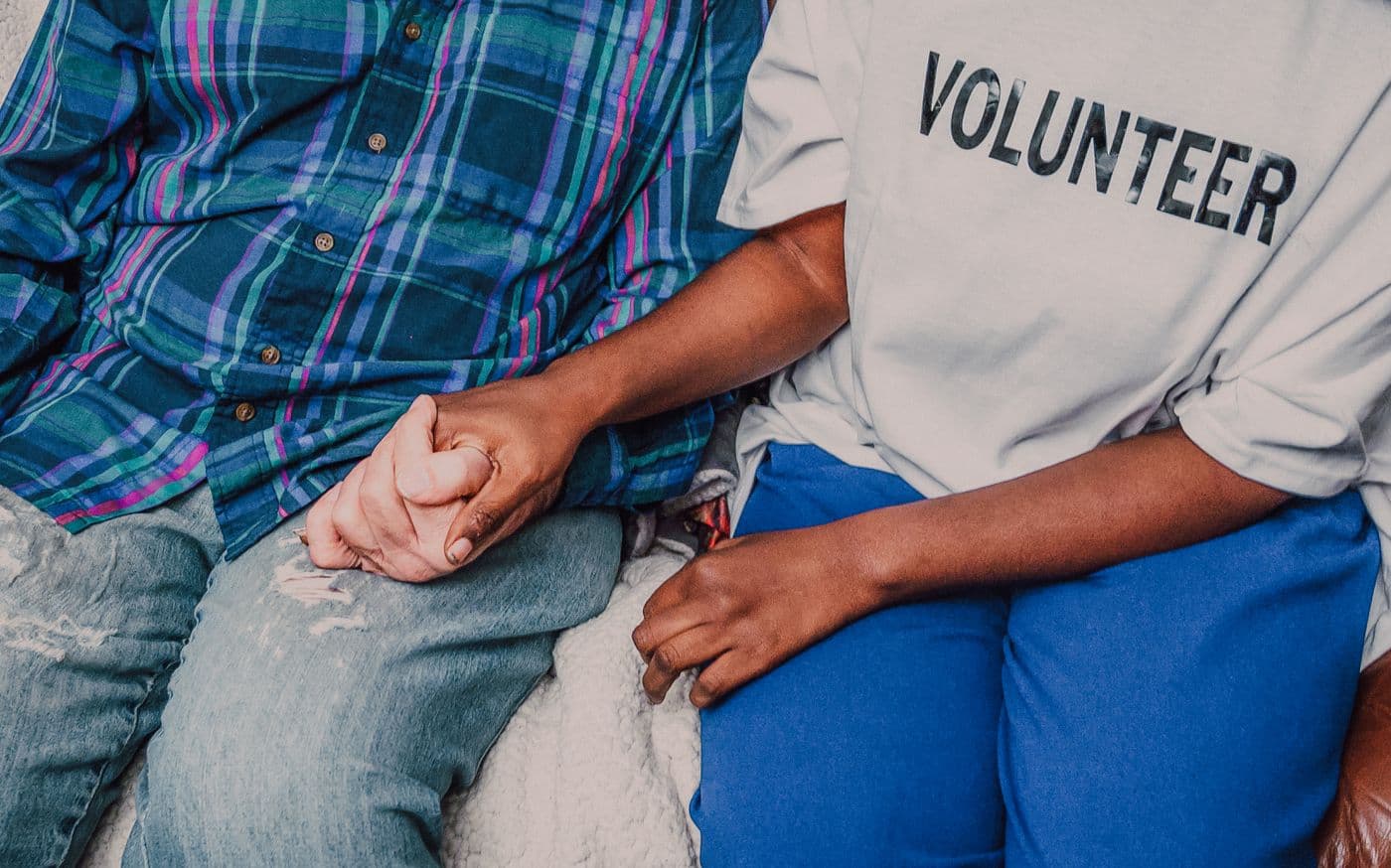 A volunteer holding someone's hand.